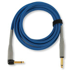 A coiled blue audio cable with gray plugs and gold connectors, secured with a black strap on a white background.