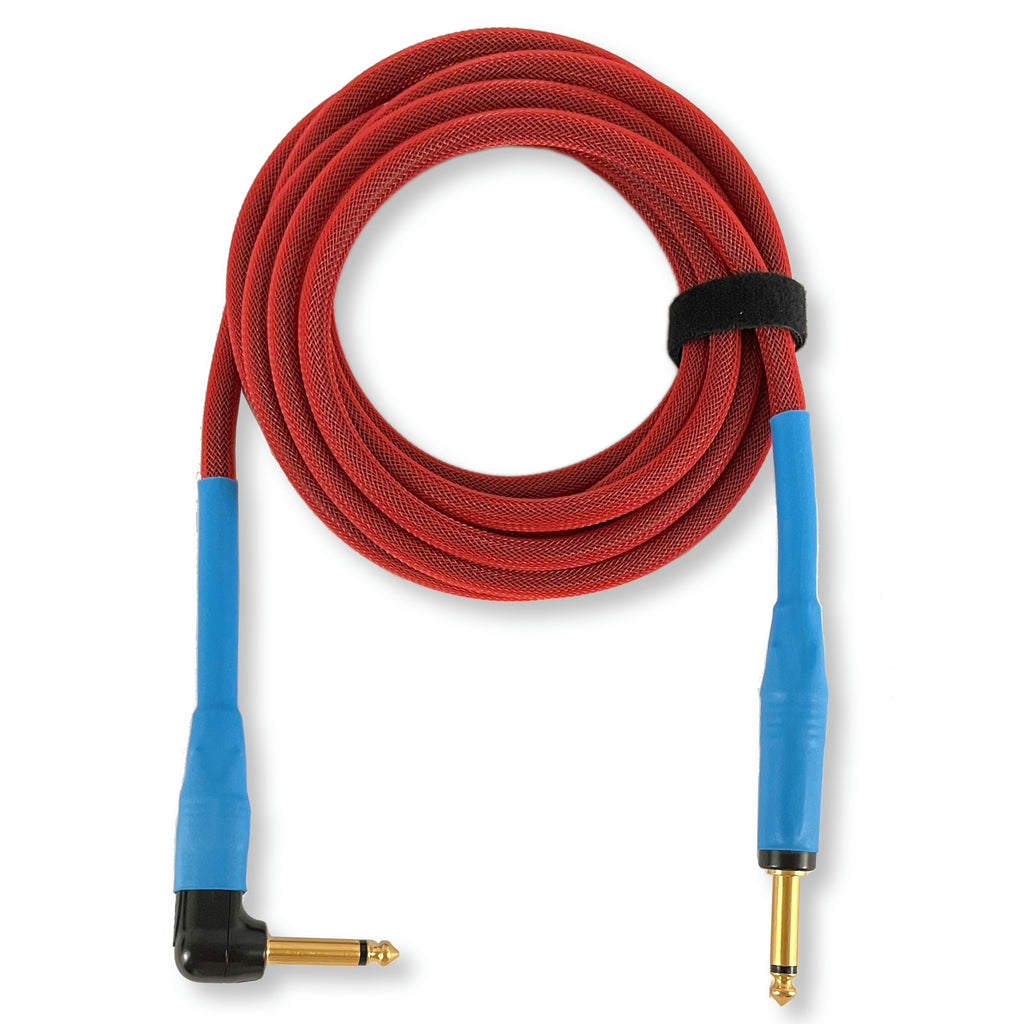 A coiled red audio cable with blue angled plug sleeves and gold-plated connectors, secured with a black strap on a white background.