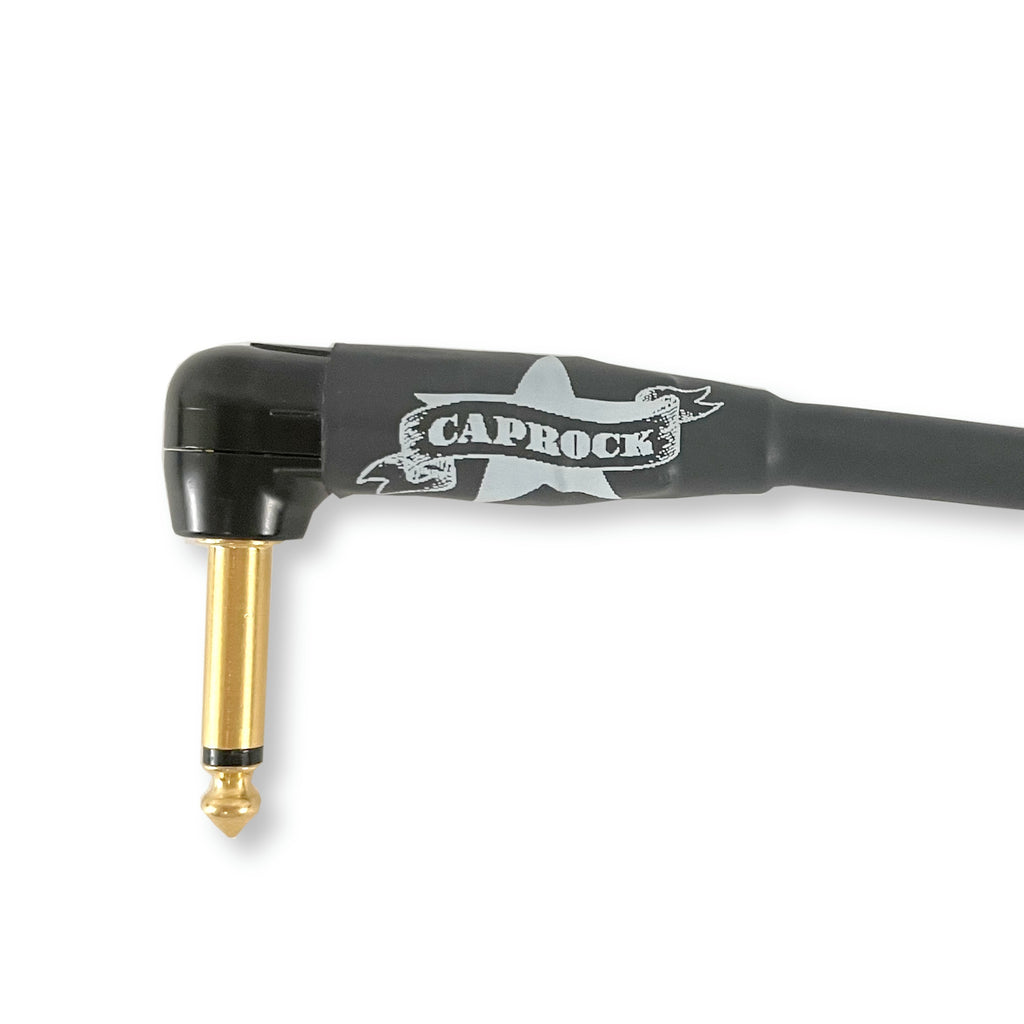 A black right-angle audio cable with a gold 1/4-inch jack plug and a black handle featuring a white 'CAPROCK' logo, shown on a white background.