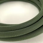 A close-up of a coiled olive green braided cable or cord on a plain light background.
