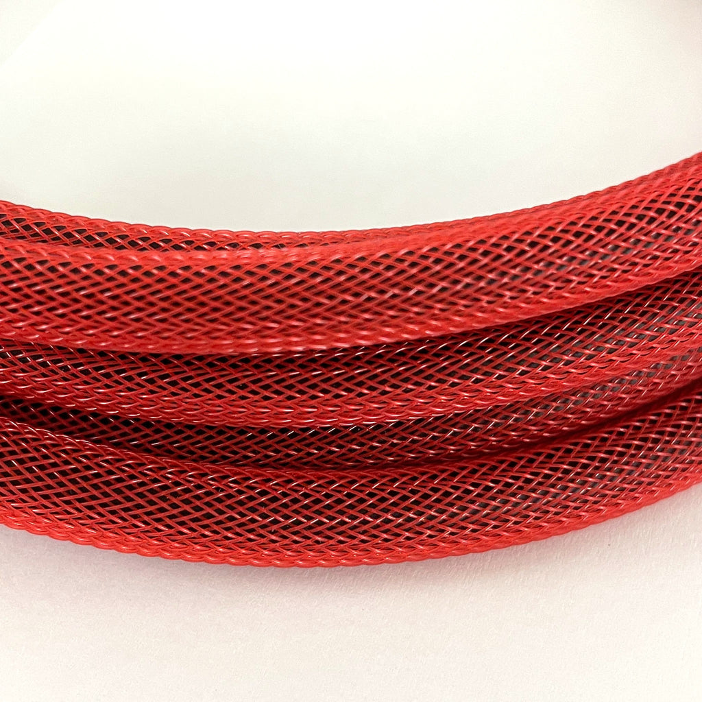 A close-up of a bright red braided mesh cable on a plain white background.